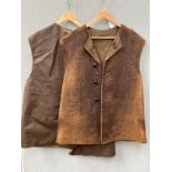 A WWII 1945 dated No. 2 leather jerkin, size No. 1, some wear, together with another dated 1961 (2)