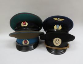 Four USSR Russian Soviet peaked visor caps: Border Guard (green with red piping), Air Force (blue