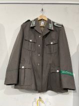 A West German Army Border Guard's jacket, 'GRENZTRUPPEN DER DDR' green band to sleeve