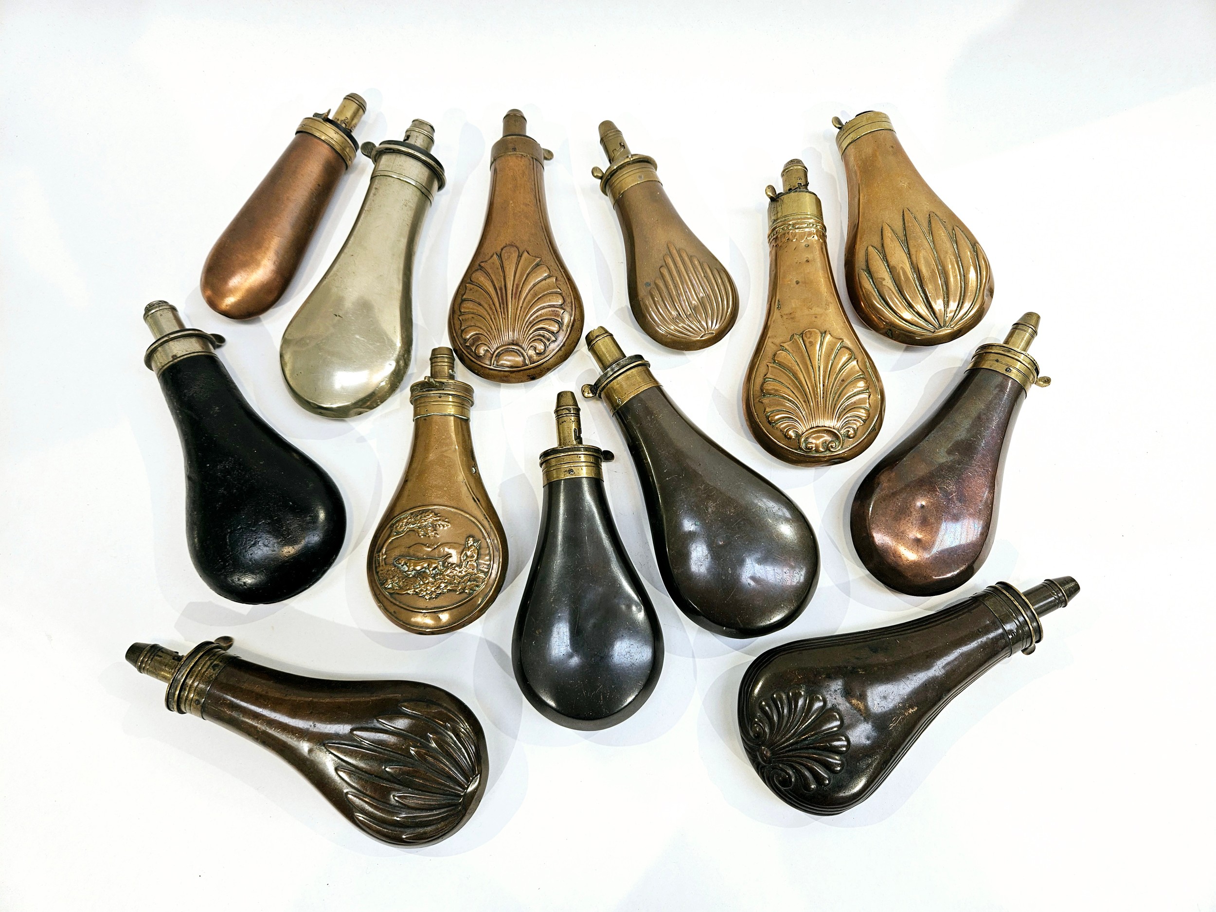 A quantity of 19th Century copper and brass powder flasks
