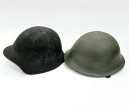 A Swiss M18/40 helmet together with a post-war British Army helmet (2)