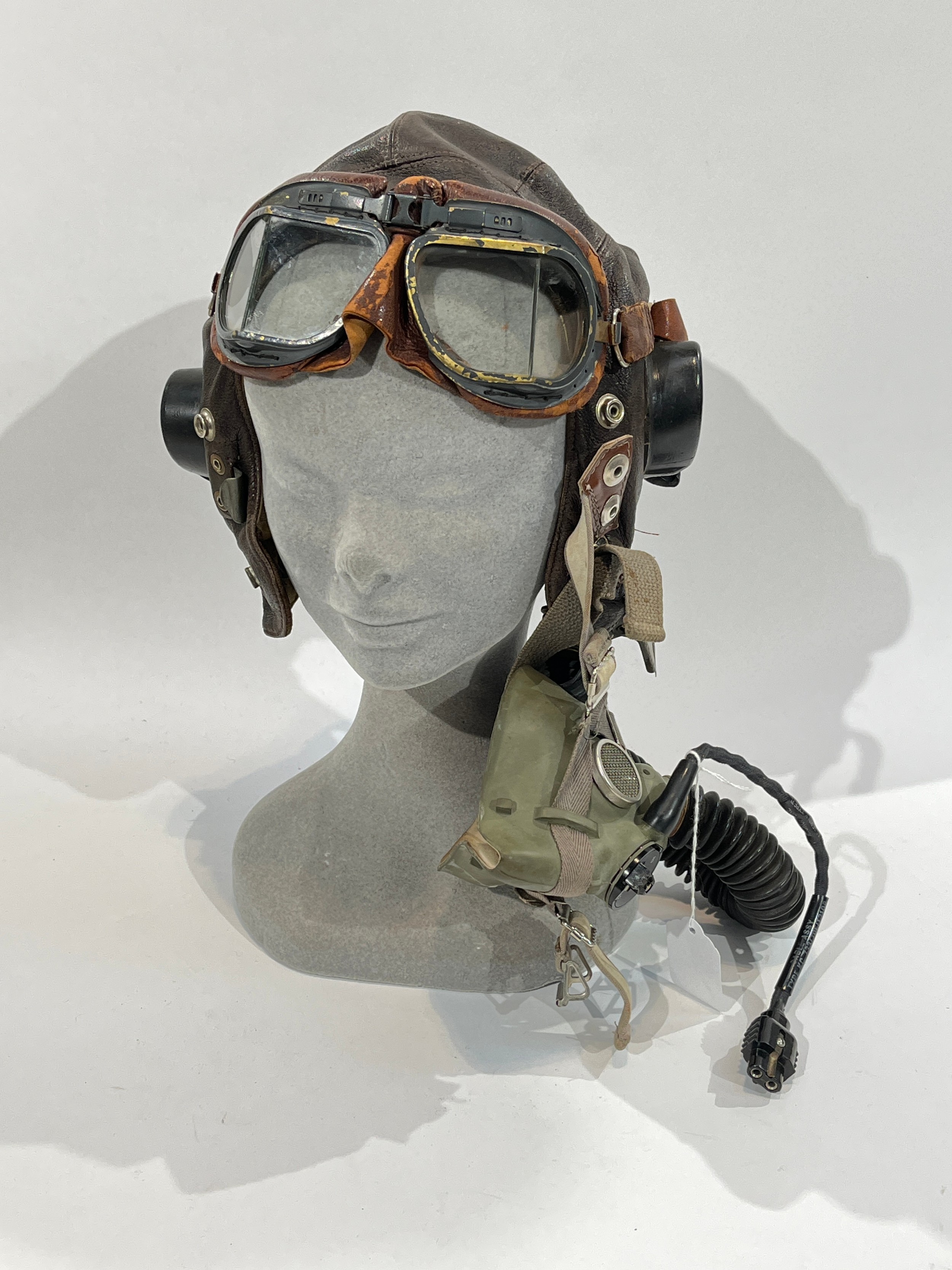 A WWII British RAF C-Type leather flying helmet together with goggles and respirator