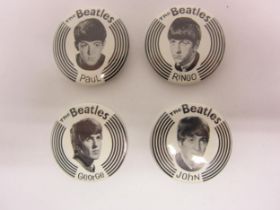 THE BEATLES: A set of four Norman Drees Associates Beatles lapel badges, c.1963