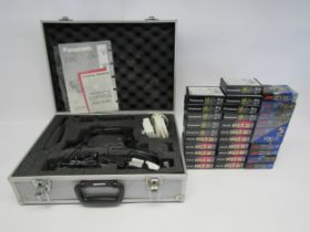 A cased Panasonic NV-RX49B video camera with thirty-one sealed and unused tapes