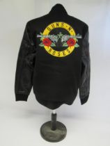 GUNS N ROSES: A black varsity style jacket with leather sleeves (size M, unworn)