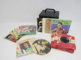 ELVIS PRESLEY: A vintage record case containing a collection of thirty 7" vinyl records to