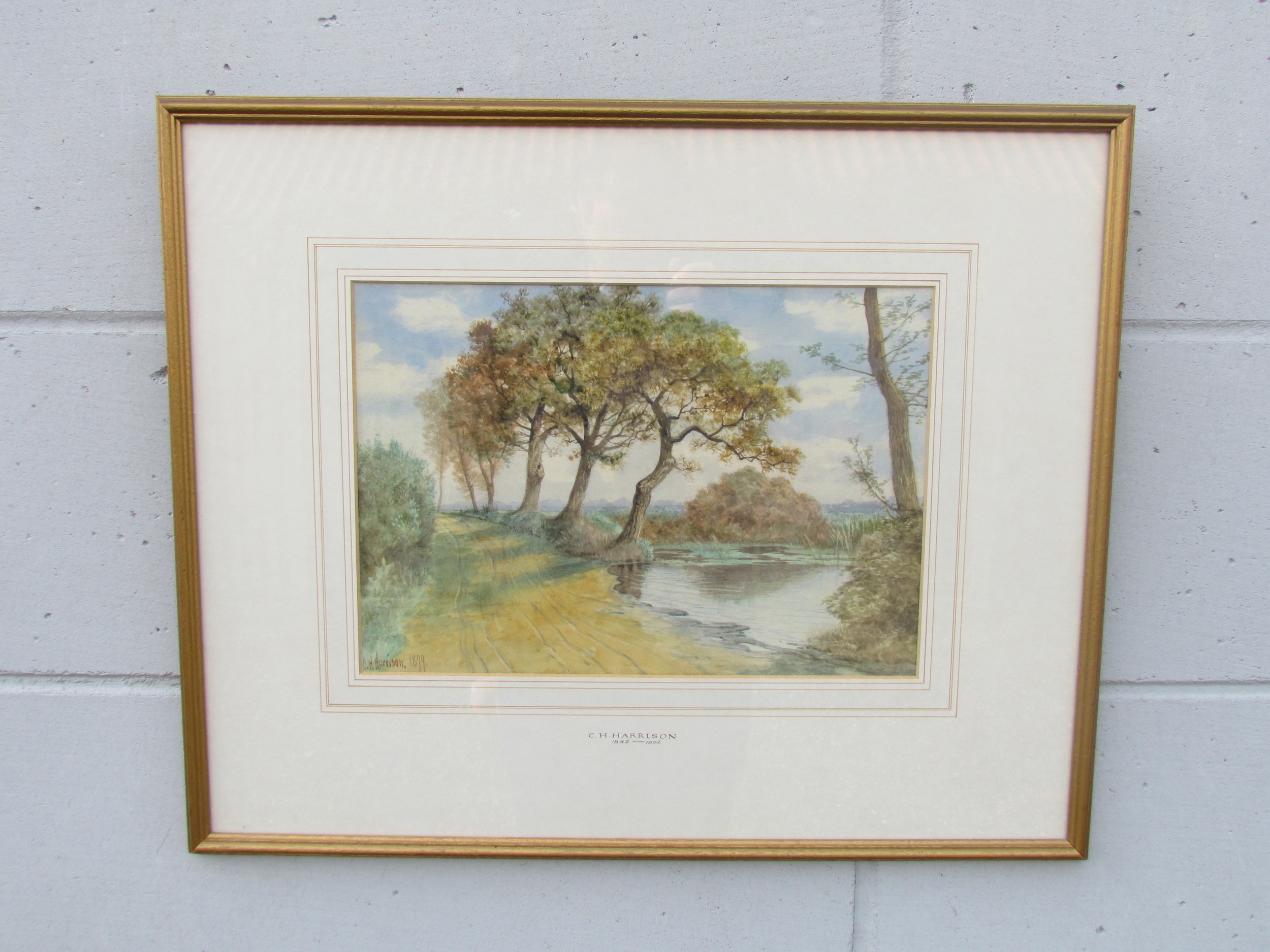 CHARLES HARMONY HARRISON (1842-1902) A framed and glazed watercolour, Broadland scene with trees.