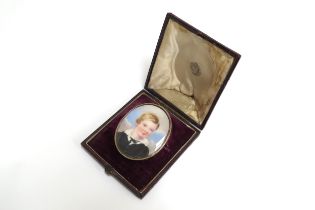 A 19th Century miniature watercolour on oval ivory panel, portrait of a young boy wearing a white