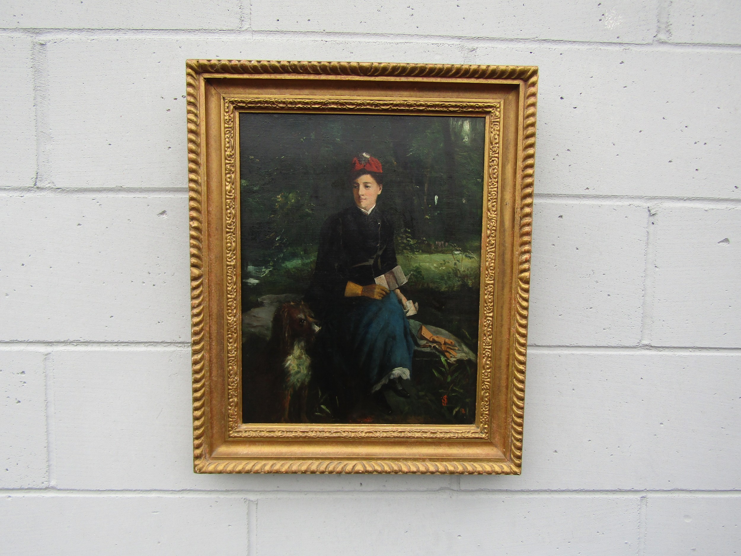 A 19th Century oil on canvas (relined) of a lady seated on a bolder with dog beside her, artists