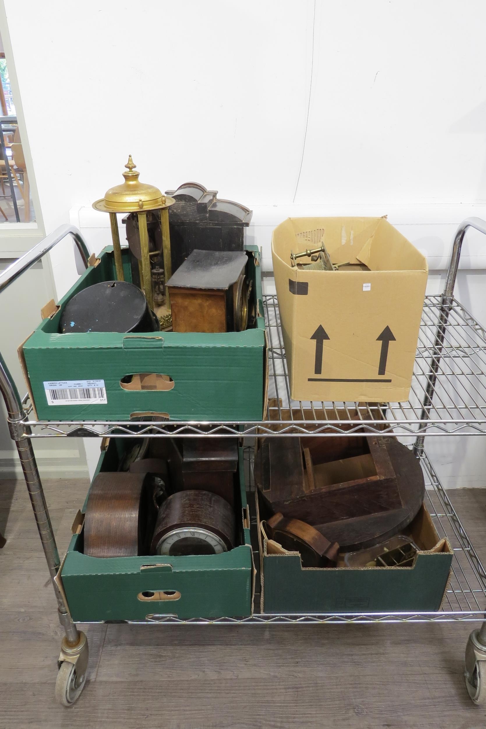 Four boxes of mixed clock parts incluyding cases, movements, wristwatches, etc.