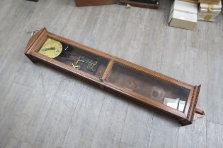 An oak cased wall hanging electric master clock with a double glass paned door, Arabic numeral