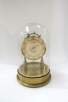 T C STOTT, Harpenden 1955, solid brass handmade electric clock under glass dome, 29cm tall.