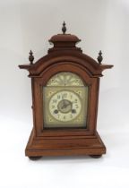 A German walnut cased architectural form striking mantel clock with Junghans movement, with