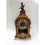 A late 19th Century French walnut and ormolu mounted striking mantel clock with ROman enamel