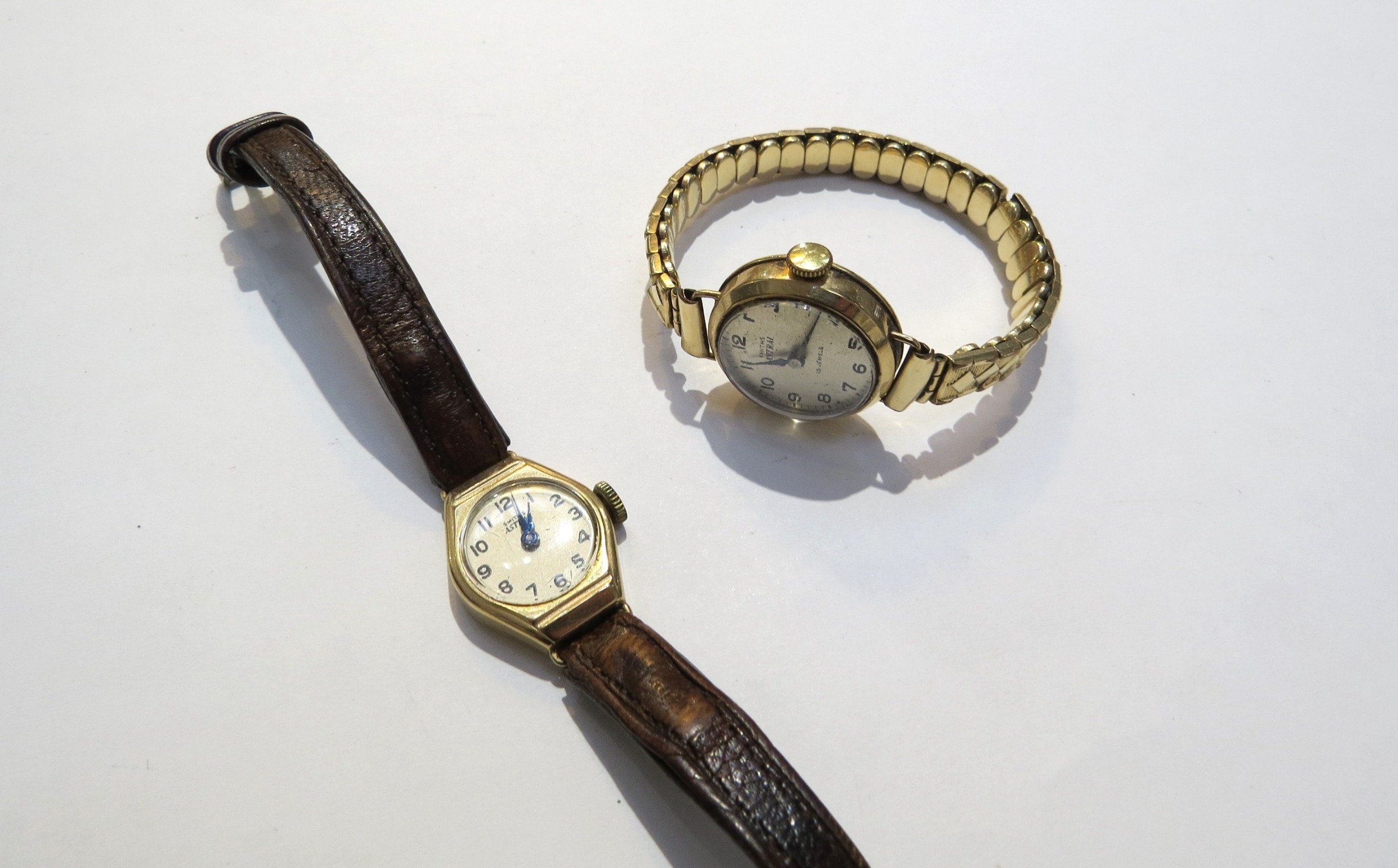 Two 9ct gold cased Smiths Astral ladies wristwatches, one on leather strap, other on 9ct gold