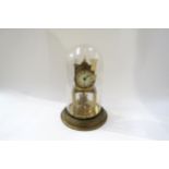 A Gustav Becker brass anniversary clock under plastic dome, 30cm tall