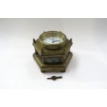 A 20th Century brass hexagonal form table clock with Roman enamelled dial, one glass panel