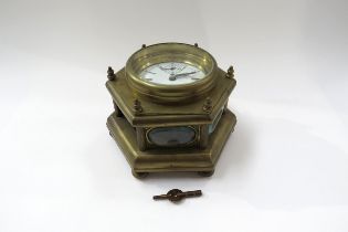 A 20th Century brass hexagonal form table clock with Roman enamelled dial, one glass panel