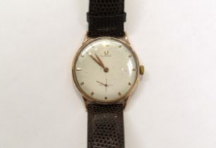 A 9ct gold omega wristwach on leather strap