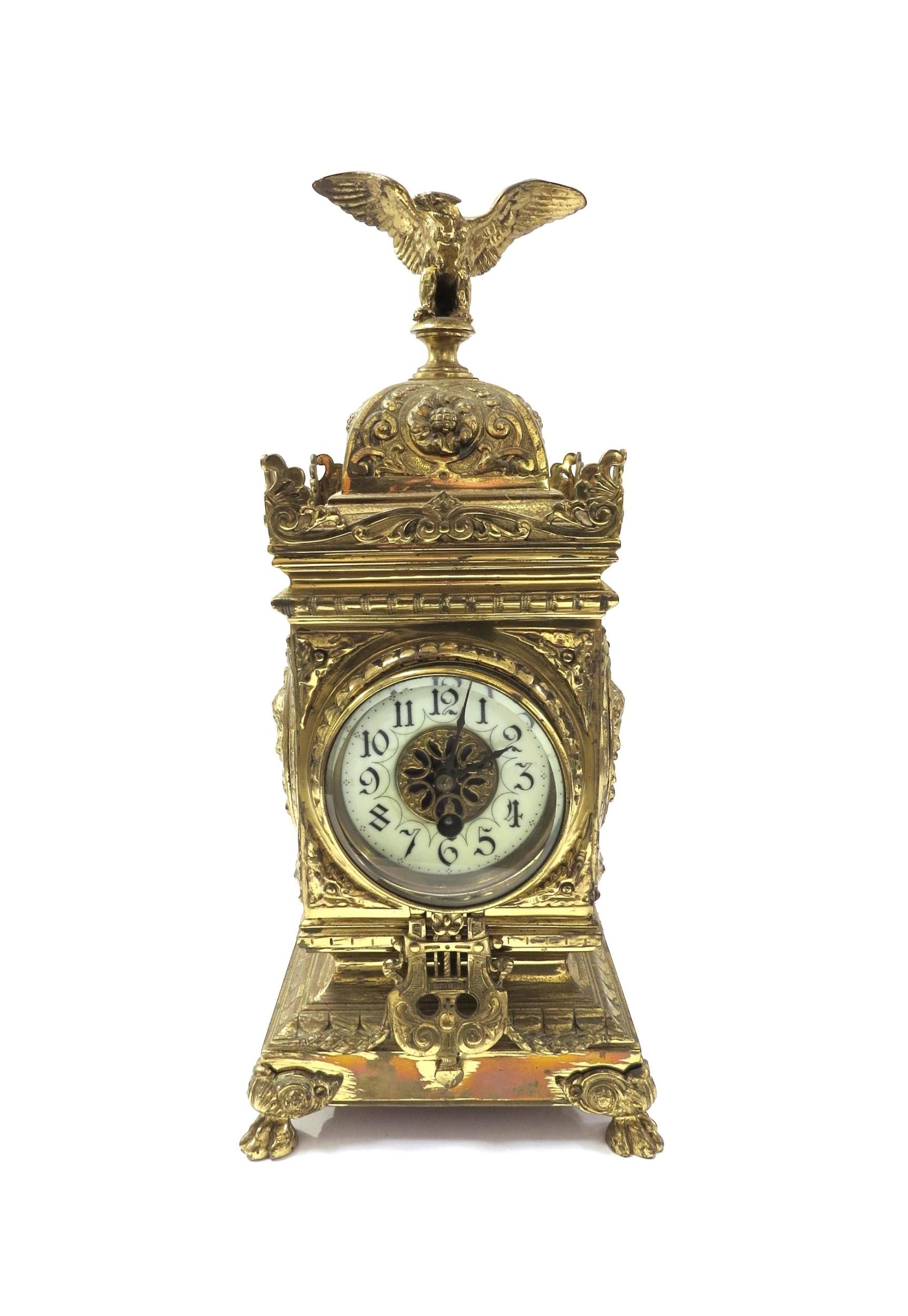 A French timepiece in highly decorative brass case, Arabic enamelled chapter ring, with pendulum.