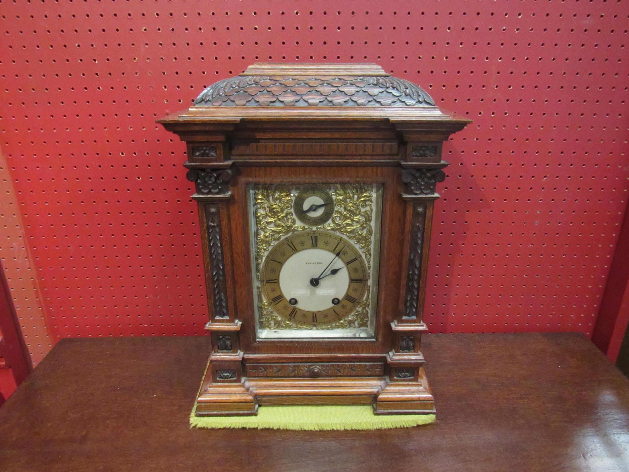 A Mahogany Elkington & Co. bracket clock, carved case and column form front, ornate decoration to