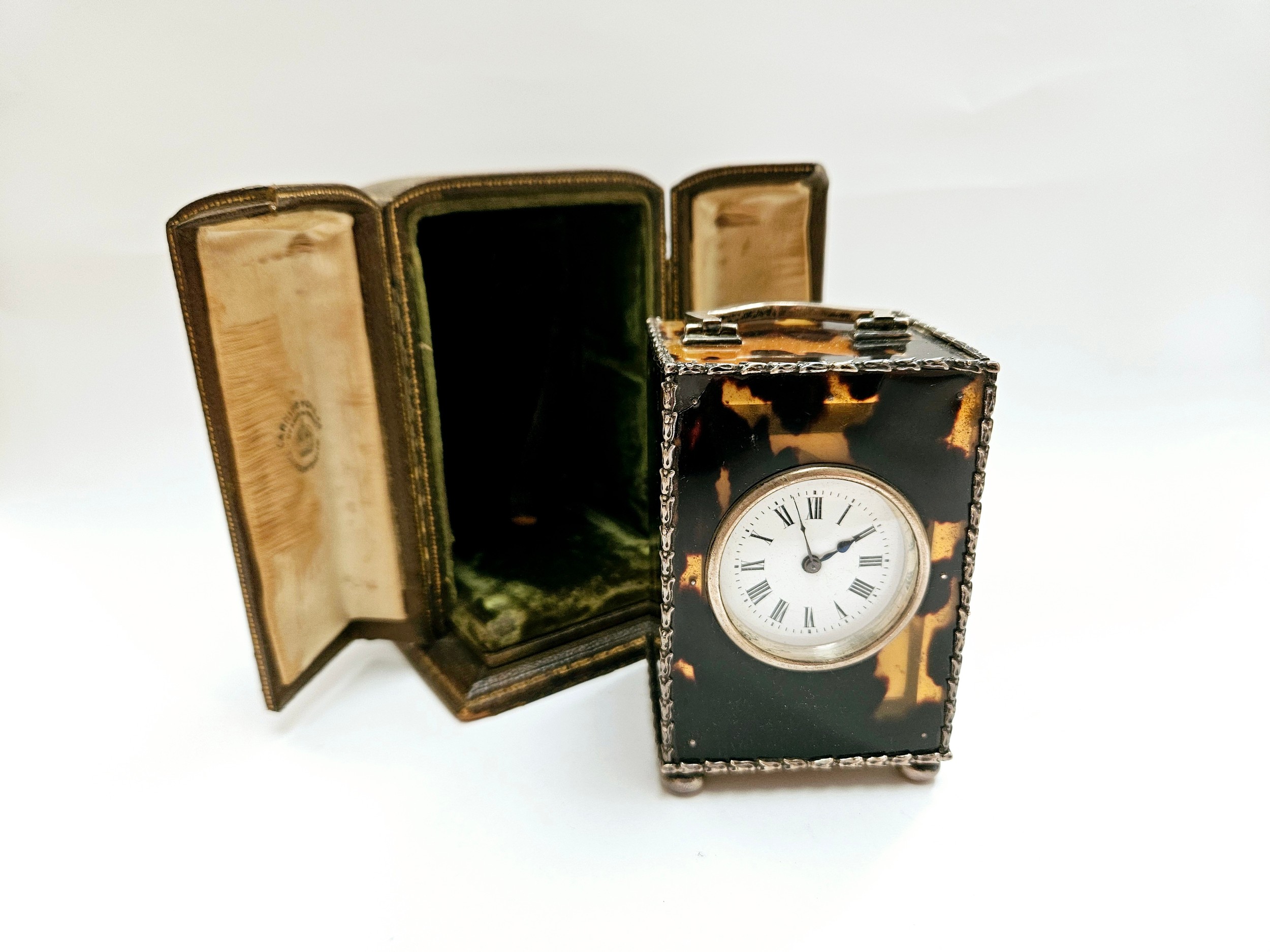 A Charles & Richard Comyns silver and tortoiseshell miniature carriage clock, with crack to top left