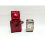 A Drew & Sons Piccadilly Circus silver minature carriage clock with red leather travel case and key.