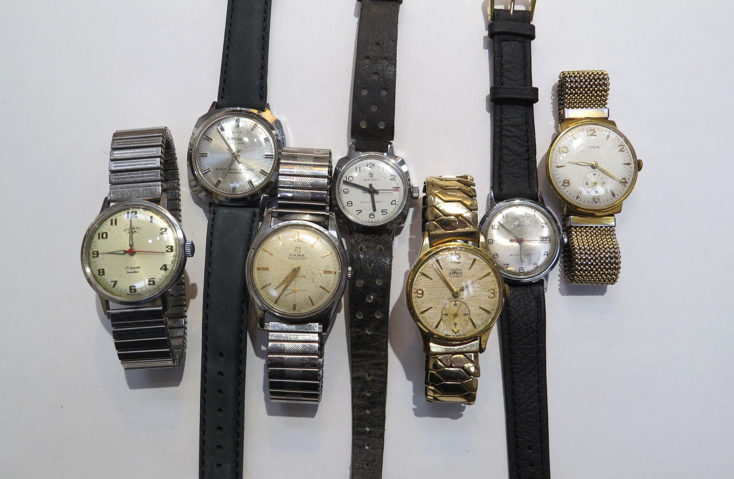 Seven manual wind wristwatches including Smiths Astral, Rotary Timor, Cyma, Services, Superoma de