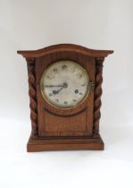 A German early 20th Century two train mantel clock with Arabic numerals in oak case, striking on a