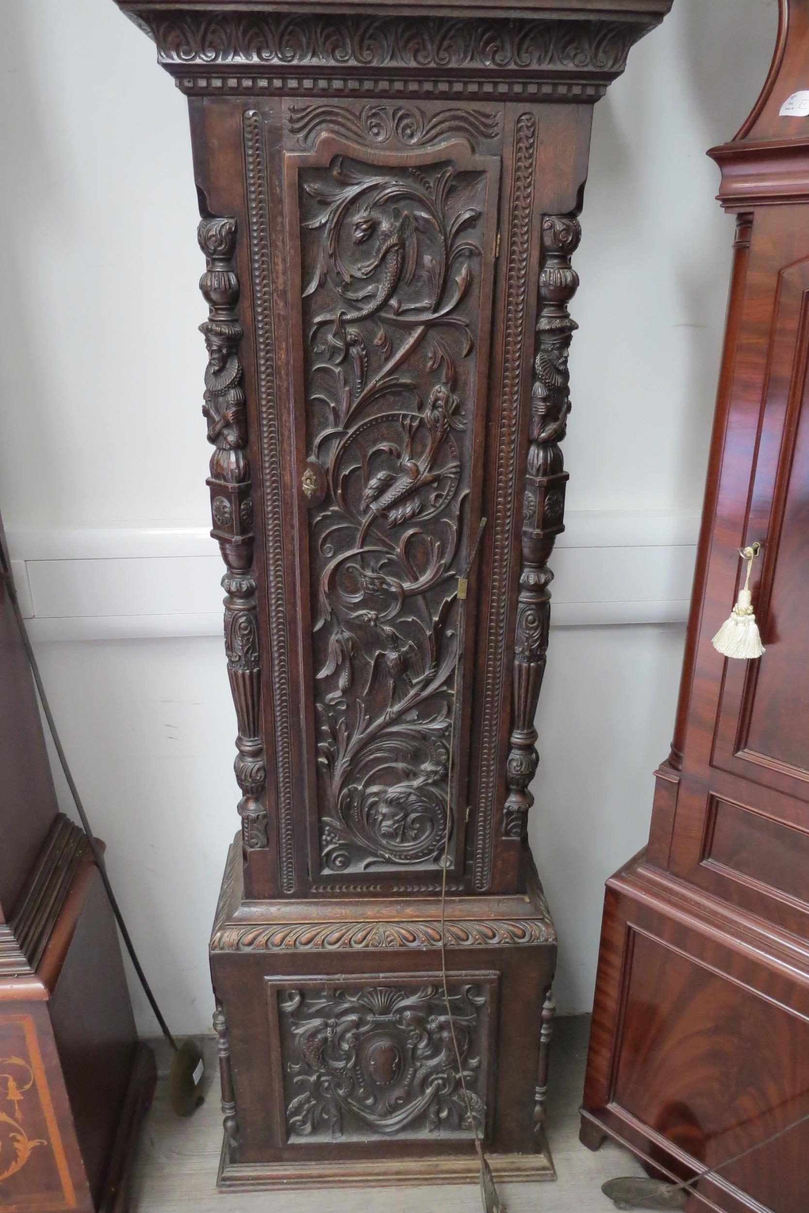 An 18th Century heavily carved oak longcase clock with silvered Roman chapter ring, date and seconds - Image 5 of 8