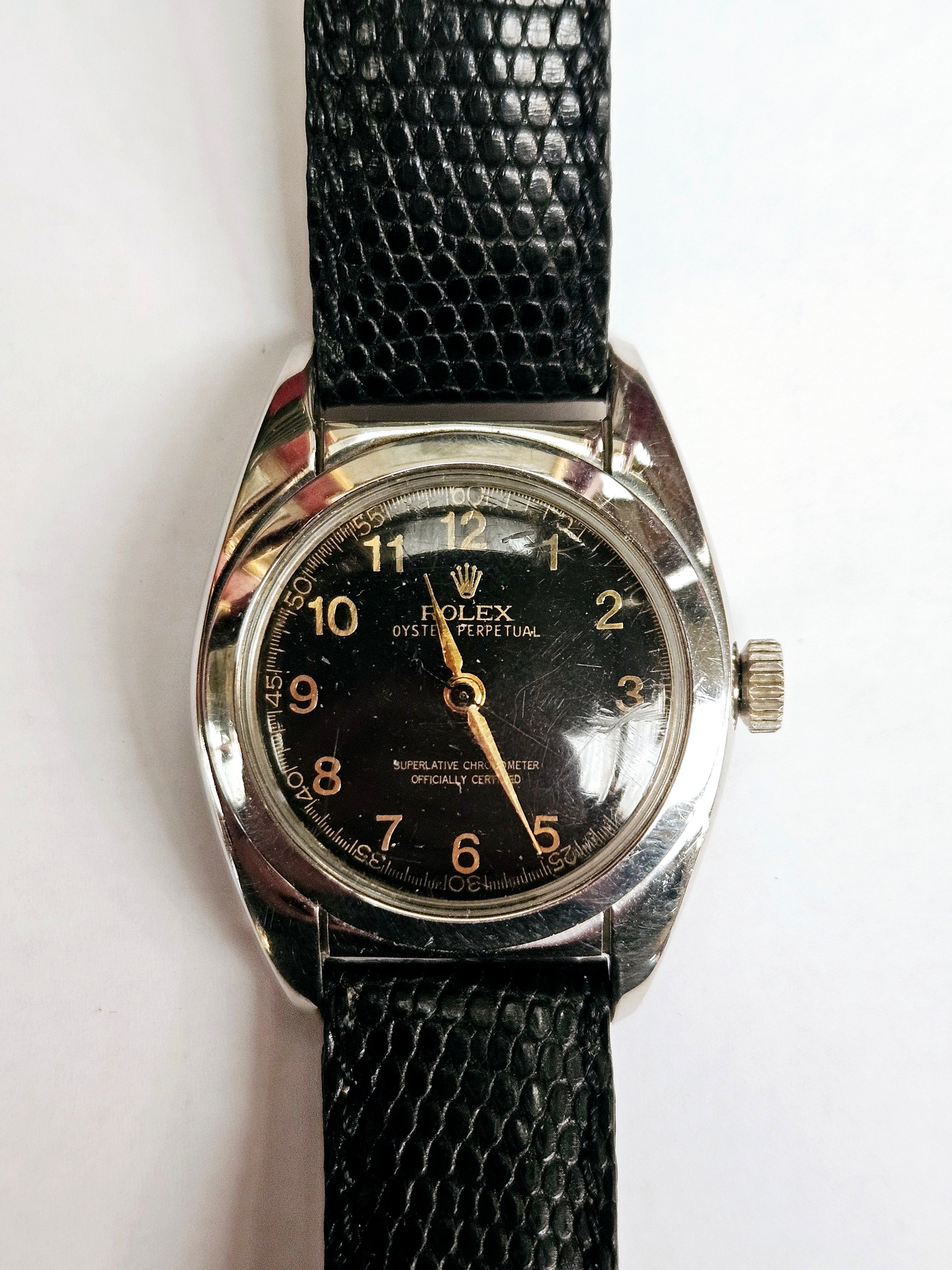 Circa 1950s Rolex Oyster Perpetual with black dial and bubble back, No. 5015, 545383 on leather