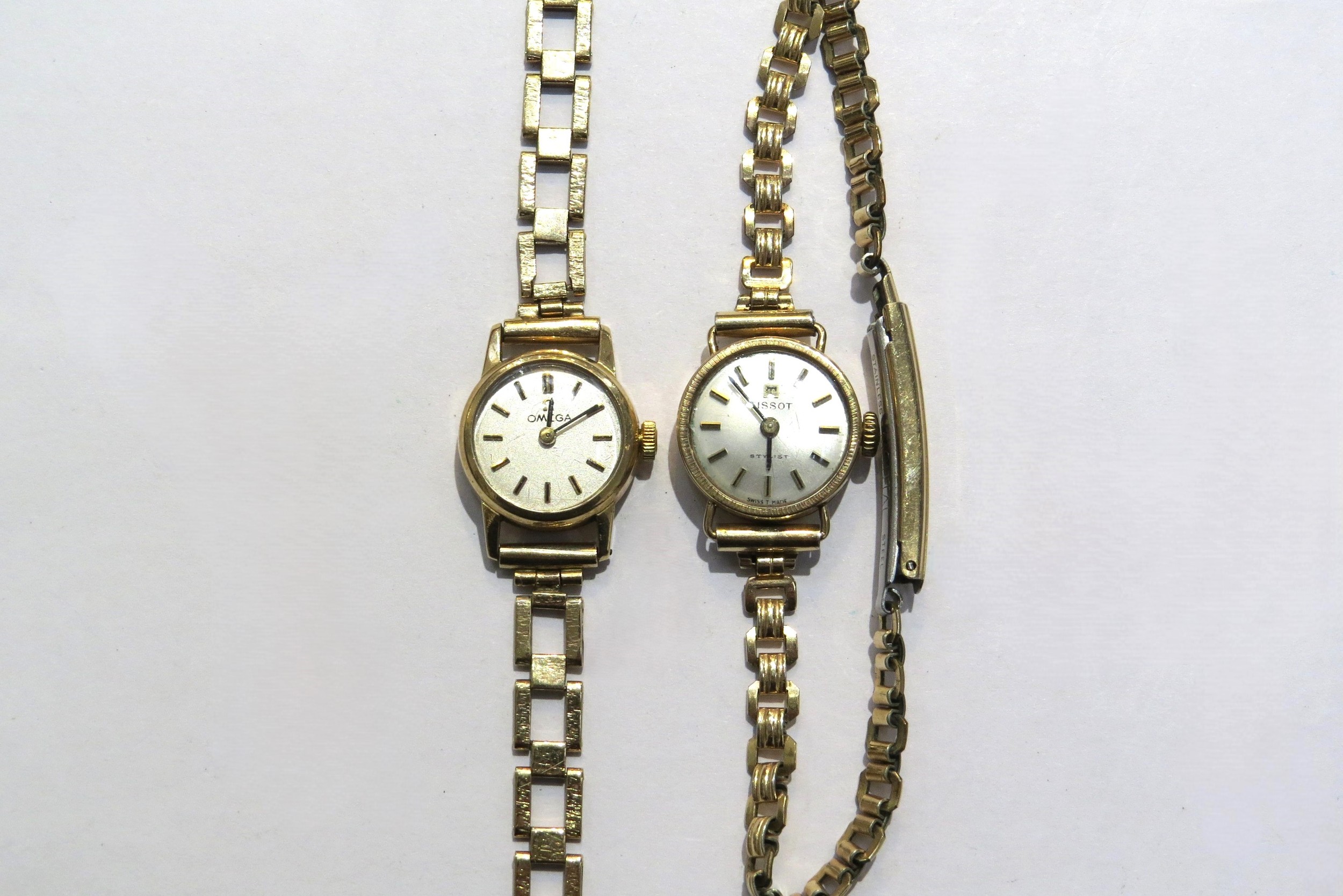 A 9ct gold cased ladies Omega with gold strap along with a rolled gold ladies Tissot Stylist, in