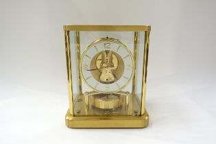 A Jaeger LoCoultre Atmos Clock no. 601102. Front glass panel is chipped, top case screws missing.