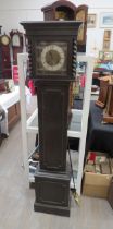 An early 20th Century oak cased striking and chiming grandmother clock. With pendulum and key.
