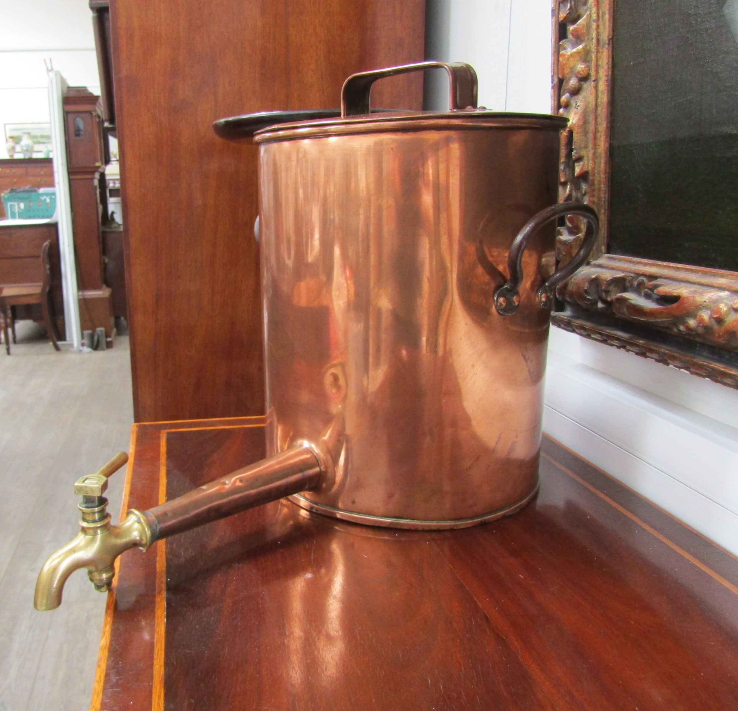A 19th Century copper urn with lid, over iron handles and brass tap stamped "Martina and Smith",