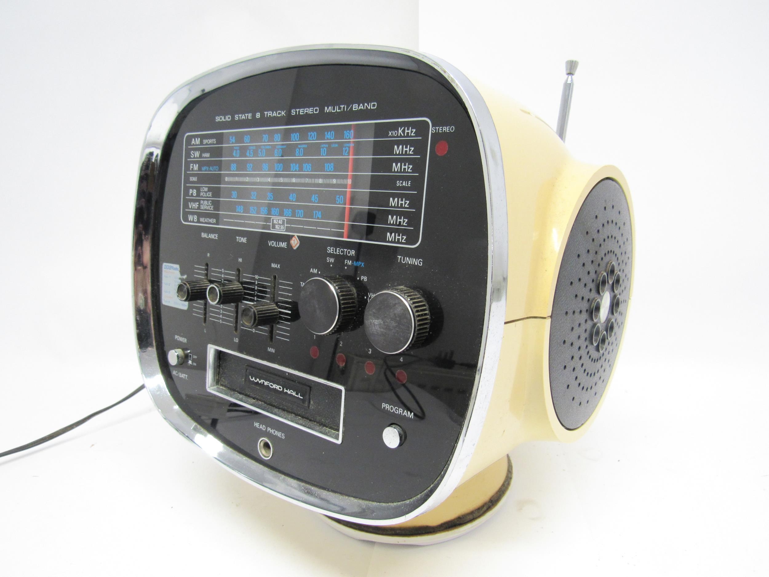 A 1970s Wynford Hall TCM-5500 8-Track stereo in space helmet form plastic casing with integrated