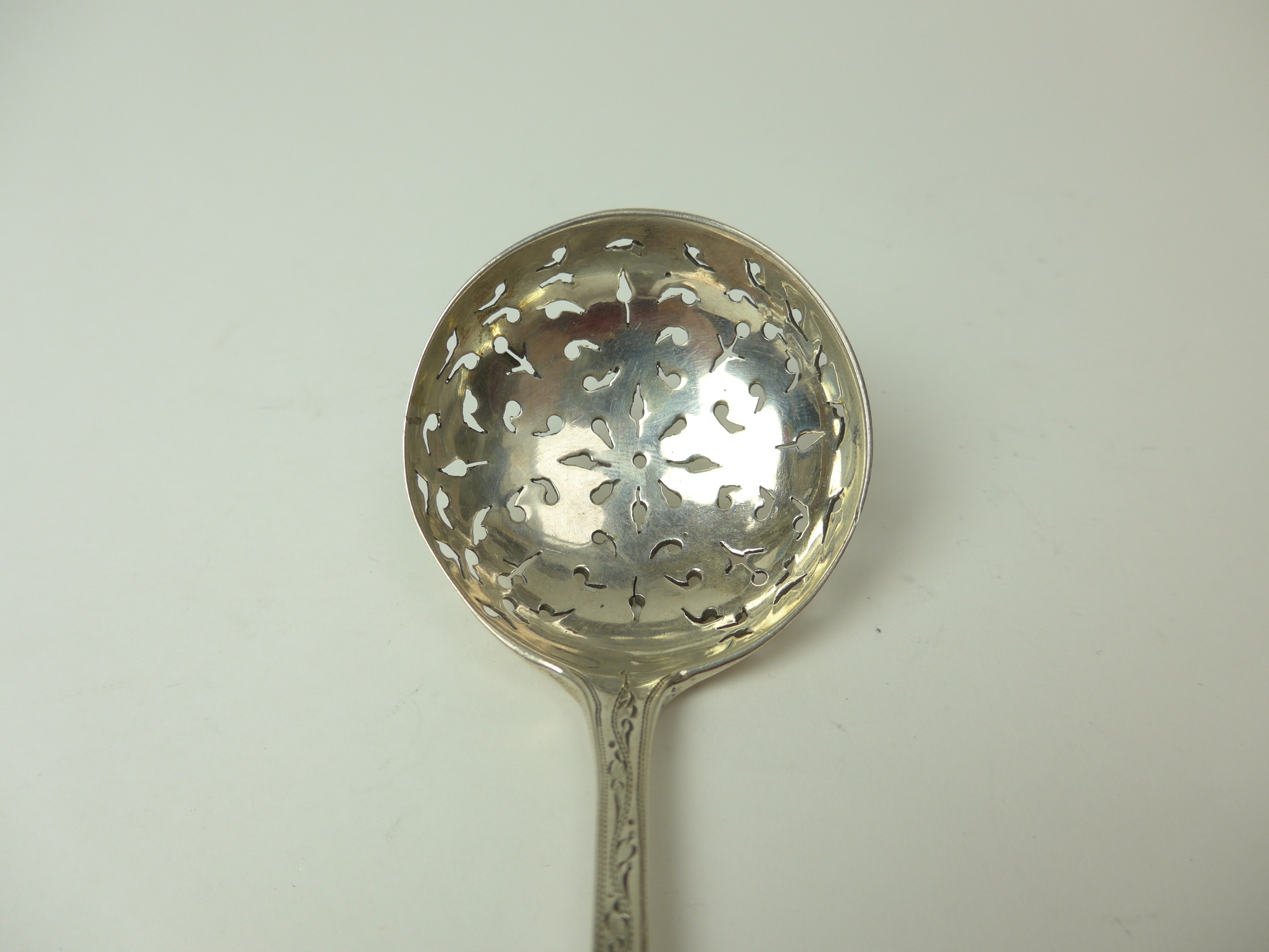 A Josiah Williams & Co silver sifting spoon with pierced terminal, 17cm long, London 1894, 40g - Image 2 of 4