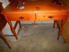 A two drawer pine side table, in good condition, COLLECT ONLY.