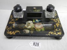 A papier mache' desk tray with painted floral design.