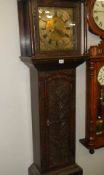 A late Georgian / early Victorian 8 day long case clock in carved oak case with brass dial, complete