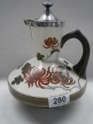 An antique Royal Doulton wine/water ewer with silver top and collar, assayed Birmingham 1883