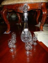 A cut glass decanter and six glasses.