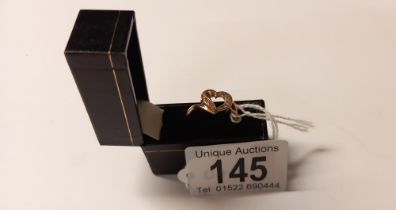 A lovely diamond chip set heart ring in gold, size O, 2.8 grams. (Unmarked)