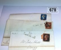 A penny black, penny red and twopenny blue stamps on postmarked envelopes.