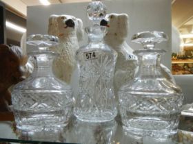 A pair of matching decanters and one other.