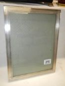 A silver photo frame, 30.5 x 23.5 cm.