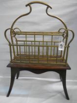 An early 20th century brass magazine rack on a wooden base.