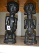 A pair of carved tribal fertility figures.