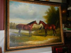 A gilt framed oil on canvas study of two racehorses. COLLECT ONLY.
