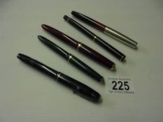 Three Parker fountain pens with gold nibs and two others.